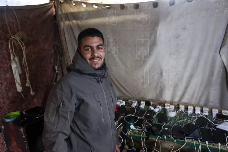 Gazans rely on phone torches for light as war destroys power grid.