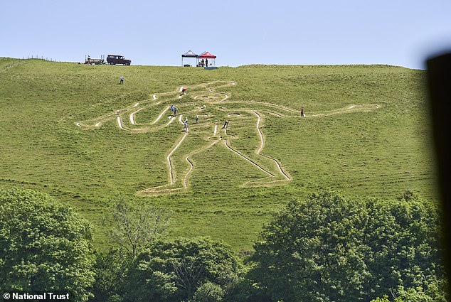National Trust volunteers restore 180-foot Cerne Abbas Giant with fresh chalk.